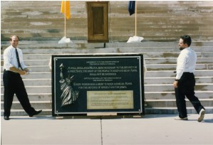Brass Roots founder Jon Coon with Brass Roots Michigan  activist Mike DeVore displaying the Plaque in front of the Michigan State Capital Building.  It was presented at a second rally in 1995.