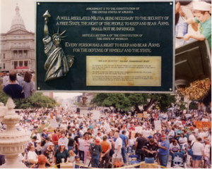 The Brass Roots Plaque (Foreground).  People at the original rally (background).